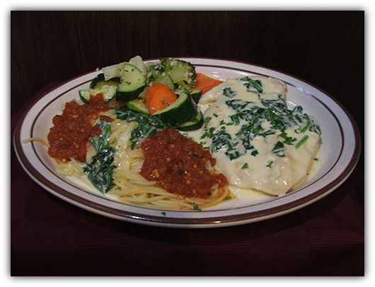 Pollo Franciscano. Chicken with green peas, prosciutto and cream sauce.