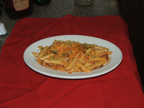 Penne Alla Vodka with flamed vodka in a pink sauce with bacon.